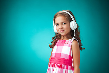 Image showing The cute cheerful little girl on orange background