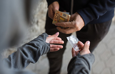 Image showing close up of addict buying dose from drug dealer