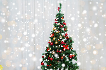 Image showing christmas tree in living room over window curtain