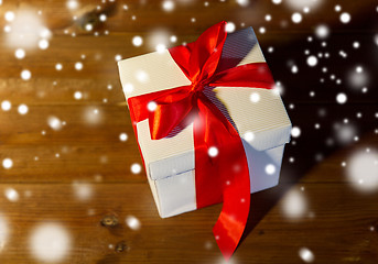 Image showing close up of christmas  gift box on wooden floor