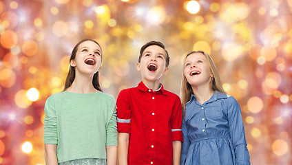 Image showing amazed children looking up over holidays lights