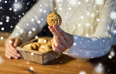 Image showing close up of woman with oat cookies at home