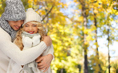 Image showing happy couple in warm clothes over autumn