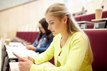 Image showing student girls with smartphones on lecture