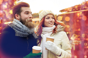 Image showing happy couple drinking coffee on old town street