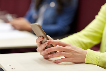 Image showing close up of student with smartphones on lecture