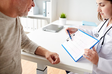 Image showing senior man and doctor with cardiogram at hospital