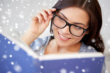 Image showing happy woman in glasses reading book at home