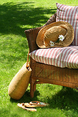 Image showing Grass lawn with a wicker chair