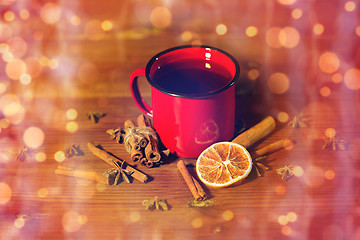 Image showing close up of tea cup with spices on wooden table