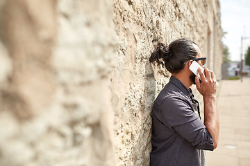 Image showing close up of man calling on smartphone in city