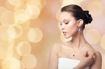 Image showing beautiful woman with jewelry over holidays lights