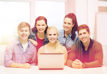 Image showing smiling students with laptop at school