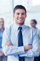 Image showing smiling businessman with colleagues in office