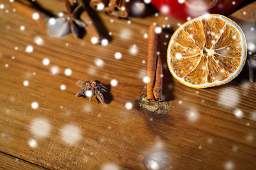 Image showing cinnamon, anise and dried orange on wooden board