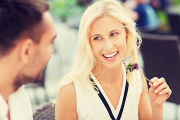 Image showing happy couple eating dinner at restaurant terrace