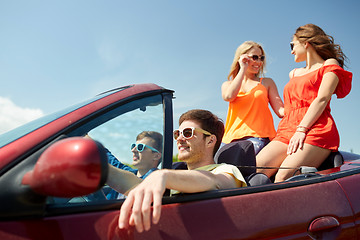 Image showing happy friends driving in cabriolet car