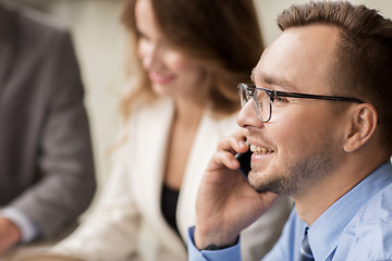 Image showing businessman calling on smartphone at office