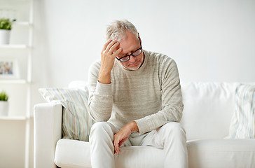 Image showing senior man suffering from headache at home