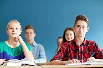 Image showing group of students with notebooks at school lesson