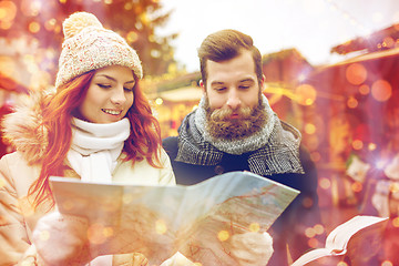 Image showing happy couple with map and city guide in old town