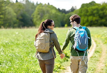 Image showing happy couple with backpacks hiking outdoors