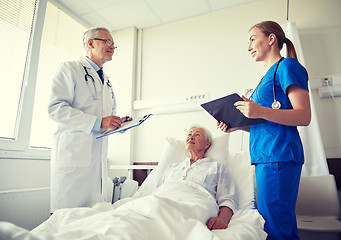 Image showing doctor and nurse visiting senior woman at hospital