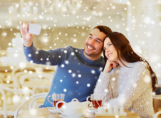 Image showing couple taking smartphone selfie at cafe restaurant