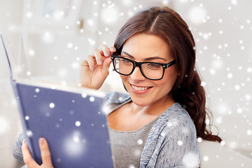 Image showing happy woman in glasses reading book at home