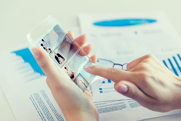 Image showing close up of woman with transparent smartphone