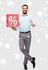 Image showing smiling man with red percentage sign over snow