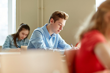 Image showing group of students with books writing school test