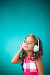 Image showing The cute cheerful little girl on orange background