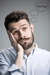 Image showing Man is looking bored. Over gray background