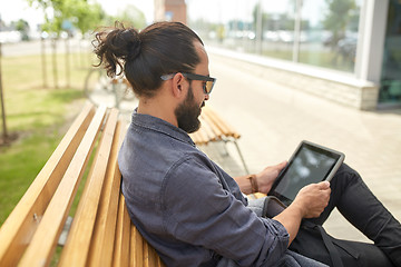 Image showing man with tablet pc sitting on city street bench