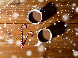 Image showing christmas candy canes and cups on wooden table