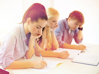 Image showing tired students with notebooks at school