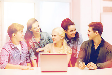 Image showing smiling students with laptop at school