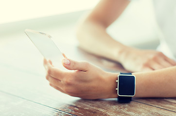 Image showing close up of hands with smart phone and watch