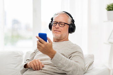 Image showing happy senior man with smartphone and headphones