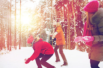 Image showing happy friends playing snowball in winter forest