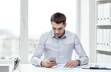 Image showing close up of businessman with smartphone