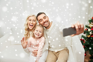 Image showing family taking selfie with smartphone at christmas