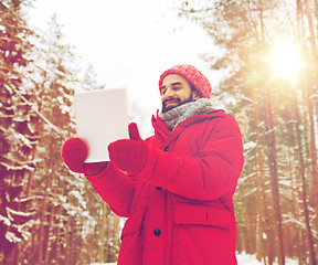 Image showing happy man with tablet pc in winter forest