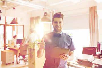 Image showing happy creative male office worker with tablet pc