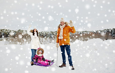 Image showing happy family with sled walking in winter outdoors