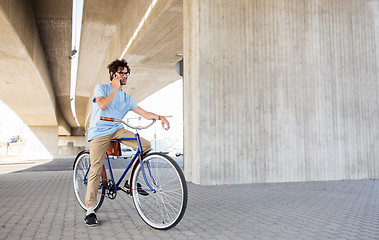 Image showing man with smartphone and fixed gear bike on street