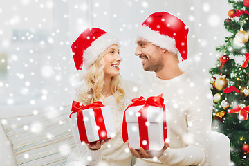 Image showing happy couple at home exchanging christmas gifts