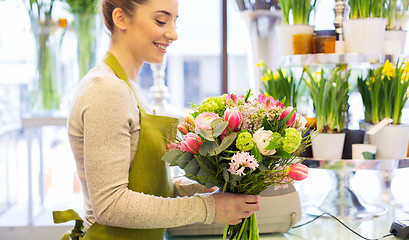 Image showing close up of woman making bunch at flower shop