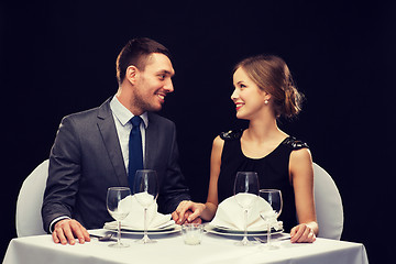 Image showing smiling couple looking at each other at restaurant